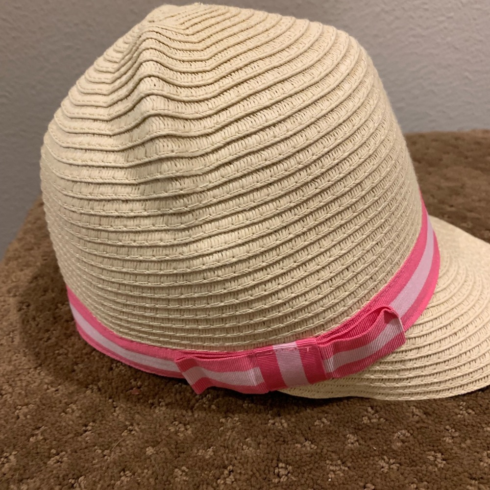 Child’s Small Cream colored Straw Hat with pink bow.